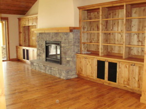 Stone fireplace and wood mantle with entertainment center